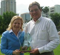 Janet Folger presents Mayor Naugle with an award